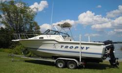 1993 Bayliner Trophy 2302 Walk around powered by a 1993 Mercury 175 outboard. Price includes a 2009 Magic Tilt Tandem axel aluminum trailer. Package is equipped with Bimini top, Ray Marine fish finer, VHF, Garmin GPS, compass, dual batteries with a