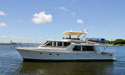 Accommodations
The 58 Offshore has a particularly inviting interior. Upon entering through the double doors from the aft deck the large U shaped settee is found to port with storage below. Across to starboard are 2 barrel chairs and a custom cabinet that