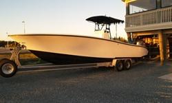 This nicely updated 31 YellowFin is a top of the line center console fishing boat. the boat features a leaning post bait well as well as a larger one in the floor. Premium upgrades include pop-up cleats, super large fish boxes, T-Top, with rocket