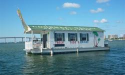 If you have spent anytime in the intracoastal near Peanut Island, you have seen this boat. You may have even been aboard and had some hotdogs or burgers. Yes, this is the Gourmet Galley houseboat.
A very big and spacious houseboat, with sliding glass