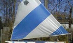 14 foot Sunfish complete with sail, mast, boom, dagger board, tiller, aluminum trailer, Dolly, Storm Cover, Blade & Spar Bag